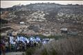 Jewish youths hold Israeli flags during a rally march outside the West Bank settlement of Itamar, near Nablus
