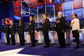 Republican presidential candidates listen to the national anthem before the start of the Republican Presidential Debate in Las Vegas