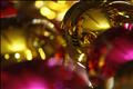 A woman painting a Christmas ornament is reflected on a bauble at a workshop in the village of Chignahuapan in Puebla