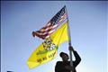 A Tea Party supporter flies his flags during the third and final day of legal arguments over the Patient Protection and Affordable Care Act in Washington