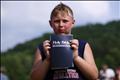 Boy with new bible after baptism during Creation08 Christian music festival in Mount Union Pennsylvania