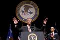 U.S. Attorney General Eric Holder of the Justice Department acknowledges the crowd and applause of U.S. President Barack Obama during a ceremonial installation at George Washington University in Washington