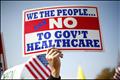A demonstrator holds up a sign at a rally on healthcare on Capitol Hill in Washington - ObamaCare