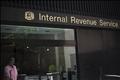 Woman walks out of Internal Revenue Service building (IRS)