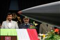 Iranian President Ahmadinejad watches as missile passes by during Army Day military parade in Tehran