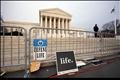 Signs are left behind after a pro-life demonstration at the Supreme Court in Washington