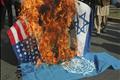 Lawyers burn an effigy of Israel's PM Olmert along with flags of the US, Israel and the United Nations in Multan, during a protest against the Israeli air strikes on Gaza