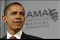 Obama pauses during a speech on health care to the American Medical Association in Chicago, Illinois