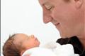 Britain's Prime Minister David Cameron holds his baby daughter, Florence Rose Endellion Cameron, in Cornwall