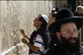 Chilean miner places a letter into the Western Wall in Jerusalem's Old City