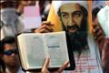 A COPY OF THE KORAN IS HELD UP DURING A AN ANTI-US RALLY IN JAKARTA.