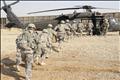 U.S. soldiers run toward a UH-60 Blackhawk helicopter during an air assault training event in Baghdad