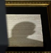 Shadow of head of U.S. President Obama falls upon copy of U.S. Constitution as he makes speech on national security in Washington