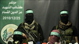 Members of Al-Qassam brigades, the armed wing of the Hamas movement, take part in a news conference in Gaza City